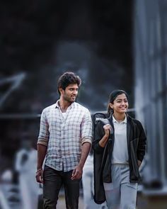 a man and woman walking down the street