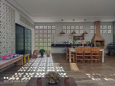 a living room filled with lots of furniture next to a dining table and fire place