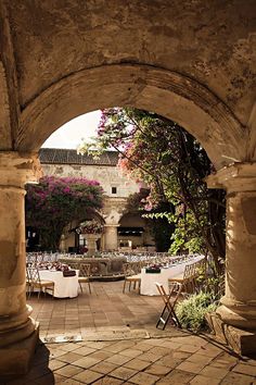 an outdoor dining area with tables and chairs set up for a formal function in the courtyard