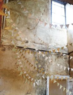 an old room with some paper garlands hanging from the ceiling