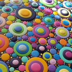 an abstract painting with circles and dots painted on it's surface in multi - colored colors