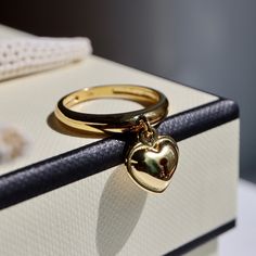 This is a lovely ring with a small heart lock dangling from it.  The lock is convex on the front and back, not flat.  That's why it feels heavy and luxurious. It is handmade and will make a great addition to any outfit. Seal everything you love with this heart lock ring. Secretly♡. *This ring is made of 14k gold vermeil over silver 925. It won't tarnish easily and will retain its golden colour for a long time. (Due to rising unit costs, we will not be reproducing them after the sale of the curre Lock Ring, Gold Heart Ring Hallmarked As Gift, Gold Heart Ring With Charm For Wedding, Gold Jewelry Ring With Heart Charm, Classic Gold Heart Ring With Charm, Gold Open Heart Ring With Charm, 14k Gold Heart Ring With Charm, Gold Heart Charm Open Ring, Gold Heart Ring With Heart Charm