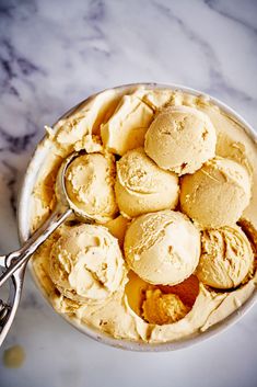 a bowl filled with ice cream next to a spoon