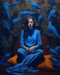 a painting of a woman sitting on a bed surrounded by blue birds