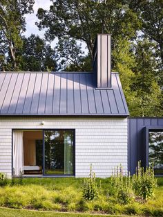 a white house with a metal roof and windows