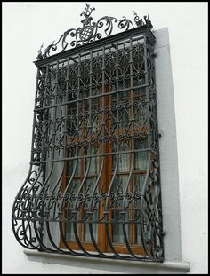 an iron window grill on the side of a building