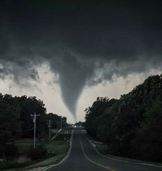 a very large tornado is coming down the road