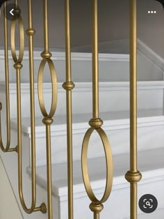 an image of stairs and railings with gold metal handrails on each side