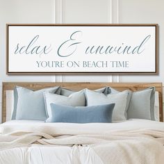 a bed sitting under a sign that says relax and enwind you're on beach time