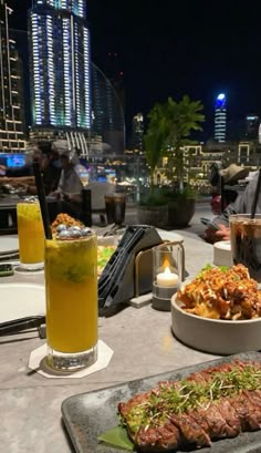 a man sitting at a table with food and drinks