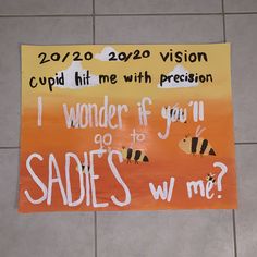 a sign on the floor that says, i wonder if you'll go to sadies w me?