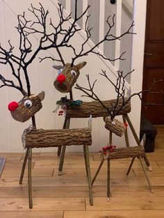 three wooden reindeer sculptures sitting on top of a hard wood floor