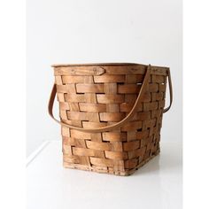 a wooden basket sitting on top of a white counter next to a bag with handles