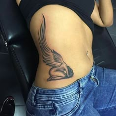 a woman with a bird tattoo on her stomach