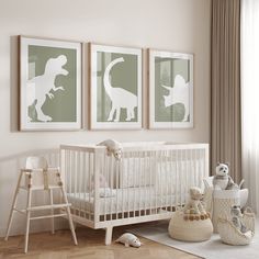 a baby's room with three framed dinosaur prints on the wall