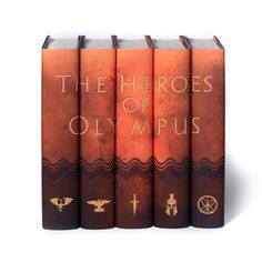 the four books are lined up in front of each other, with symbols on them