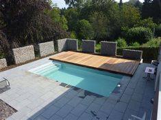 an above ground swimming pool with wooden decking