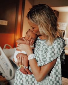 a woman holding a baby in her arms