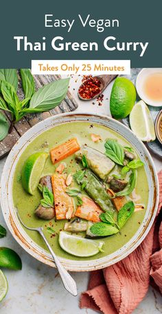 a bowl filled with green curry next to sliced limes and other ingredients on a table