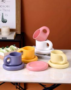 coffee cups and saucers sitting on top of a table