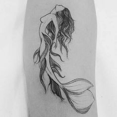 a woman's leg with a tattoo on it and an image of a mermaid