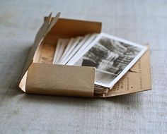 an open box filled with photos on top of a table