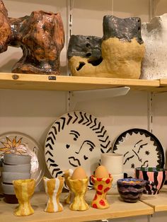 some shelves with vases and plates on them