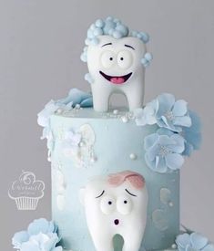 two toothbrushes on top of a blue cake