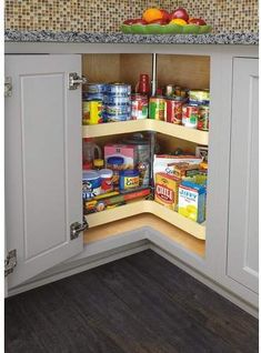 an open cabinet in the corner of a kitchen