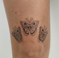 a woman's leg with three butterflies on it