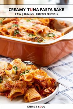 a casserole dish filled with pasta and sauce on a table next to a fork