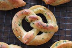 several pretzels on a cooling rack with sprinkles and seasoning