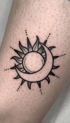 a sun and moon tattoo on the leg