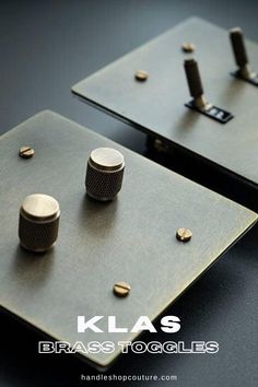 two black and gold knobs sit on top of each other in front of a dark background