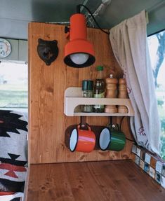 the interior of a camper with shelves, lights and other items on it's wall