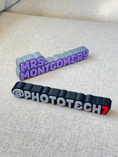 two magnets sitting on top of a couch with the word photo tech printed on them