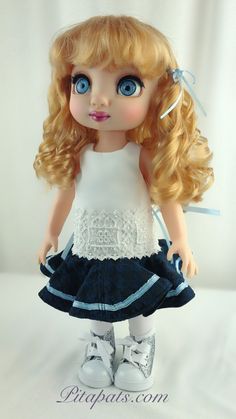 a doll with long blonde hair and blue eyes wearing a white shirt and black skirt