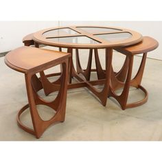 three wooden tables with glass top and circular bases