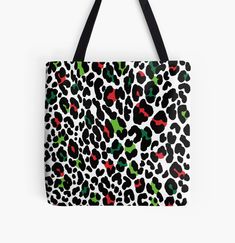 a leopard print tote bag with red, green and black spots on the front