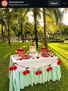 the table is set up with cupcakes and apples on it for an apple themed birthday party