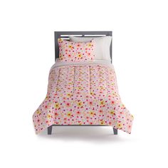 a bed with pink and yellow polka dots on the comforter, pillows and pillowcases