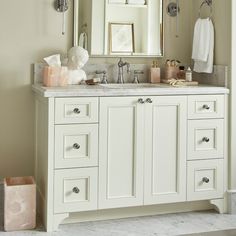 a bathroom vanity with two sinks and a large mirror