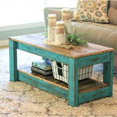 a living room with a couch, coffee table and rug on the floor in front of it