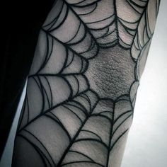 a spider web tattoo on the arm