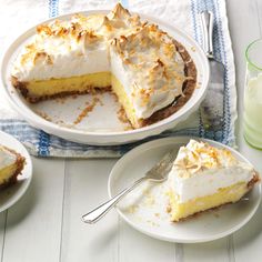 a white plate topped with a piece of pie next to two plates filled with cake