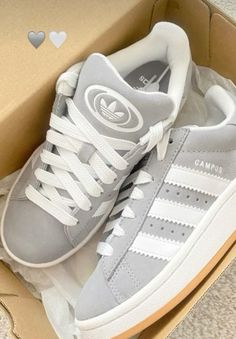 a pair of adidas sneakers in a box