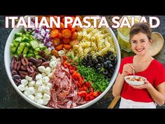 a woman standing in front of a large bowl of pasta salad