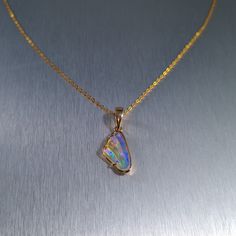 Solid carved Lightning Ridge crystal opal, set in a 14ct yellow gold pendant.  Chain not included. Opal Weight: 2.0ct Size: 16x8.8mm Pendant Length: 26mm Width: 10mm Depth: 4.5mm Materials: Lightning Ridge solid opal, 14ct yellow gold   Total Weight: 1.6gm Gold Opal Pendant Jewelry, Opal Jewelry With Polished Finish For Gift, Gold Ethiopian Opal Cabochon Jewelry, Yellow Gold Ethiopian Opal Cabochon Jewelry, Formal Gold Ethiopian Opal Jewelry, Formal Ethiopian Opal Gold Jewelry, Polished Opal Pendant Jewelry, Opal Cabochon Yellow Gold Jewelry, Yellow Gold Opal Cabochon Jewelry