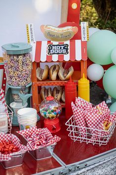 a table topped with lots of food and balloons