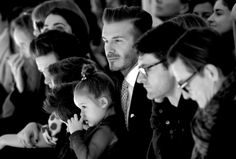 a group of people sitting next to each other in front of a man and woman